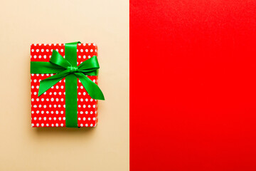 holiday paper present tied yellow ribbon bow top view with copy space. Flat lay holiday background. Birthday or christmas red present. Christmas gift box concept with copy space