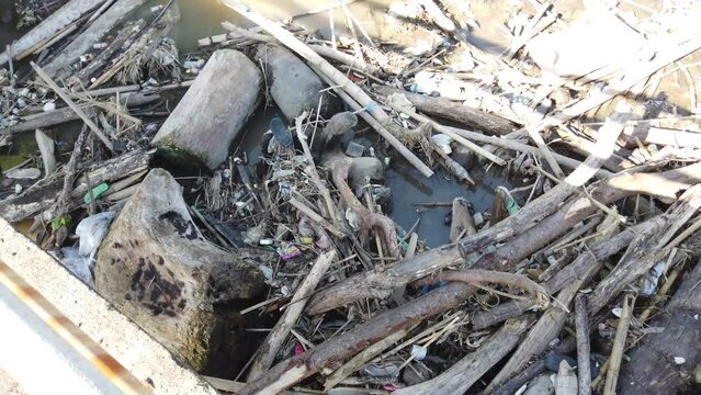 River Blocked With Plastic Trash in Bali Indonesia Polluted Natural Environment, Stagnant Wood