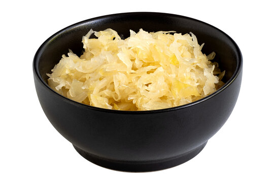 Fermented white cabbage in a black ceramic bowl isolated.