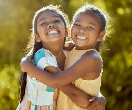 Happy Children, Sisters And Girl Friends Hug For Love, Care And Bond In Sun Park, Summer Garden And Backyard In Outdoor Colombia. Big Smile, Funny And Playful Portrait Of Young Kids Hugging Together