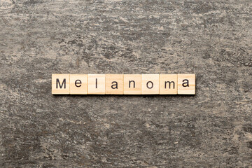 melanoma word written on wood block. melanoma text on table, concept