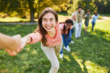 Young people pulling hands in a competition