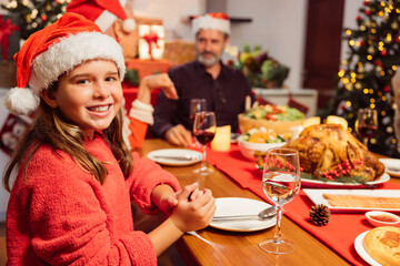 Merry Christmas! Happy family are having dinner at home. Celebration holiday and togetherness near tree