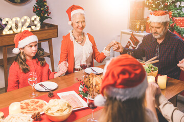 Merry Christmas! Happy family are having dinner at home. Celebration holiday and togetherness near tree