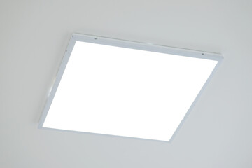 Close up shot of LED light on ceiling. White panel of modern LED light on the ceiling in office