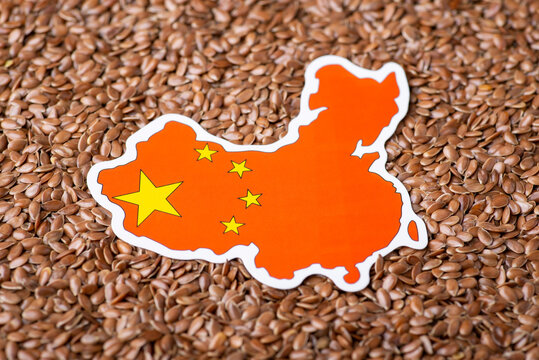 Little Paper Flag Of China On Linen Grain. Concept Of Origin Of Grain, Agribusiness In China