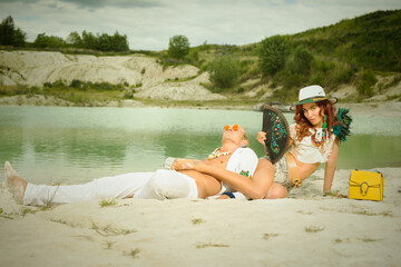 Nice couple in stylish dress posing on location of kaolin lake
