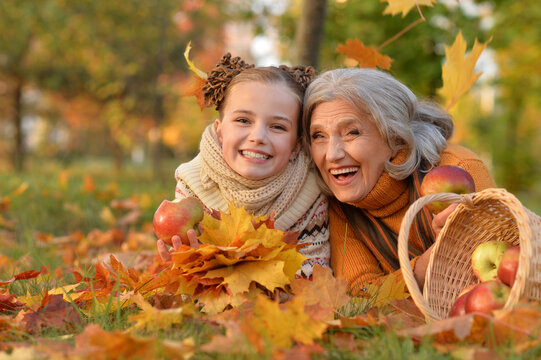 Portrait of nice grandmother of granddaughter in autumn