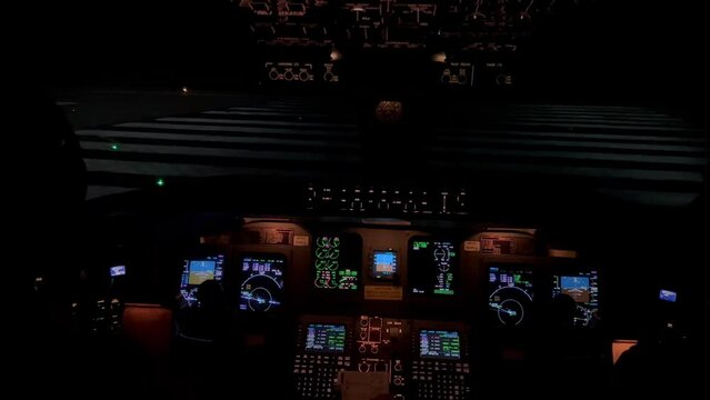 Stunning view of a jet cockpit aligning in the runway for departure. Night view.