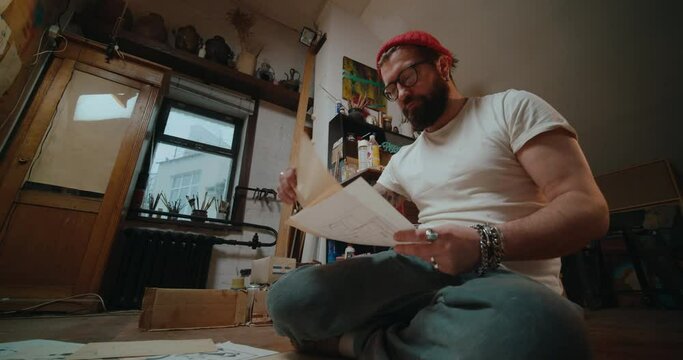 The artist draws sketches of comic book characters on paper. The illustrator creates a storyboard.