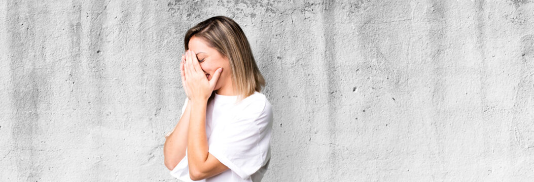 Blonde Adult Woman Covering Eyes With Hands With A Sad, Frustrated Look Of Despair, Crying, Side View