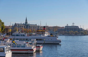 The down town bay Nybroviken with archipelago commuting boats a colorful autumn day in Stockholm