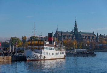Tourists enter a steam boat for a sightseeing tour in the archipelago a colorful autumn day in...
