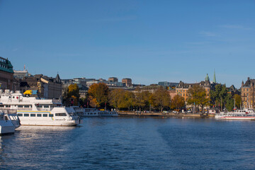 Fototapeta na wymiar The down town bay Nybroviken with archipelago commuting boats a colorful autumn day in Stockholm