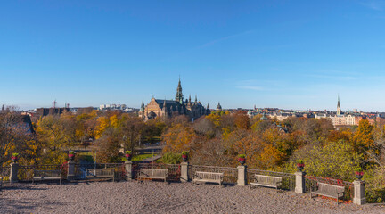 Panorama view, terrace with benches and flower pots, old gothic museum building, northern district a colorful autumn day in Stockholm