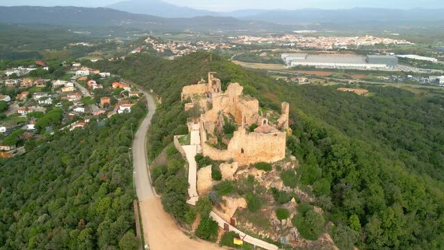 Ruined castle in Europe aerial footage cinematic medieval era  Located in Palafolls province of Barcelona Spain on top of a mountain