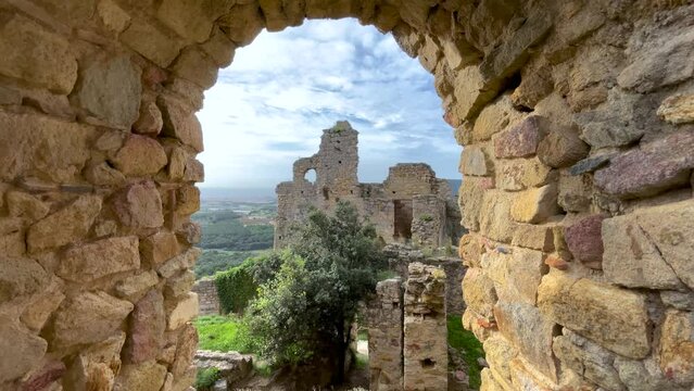 View through a window of a destroyed medieval castle in Spain Palafolls turismo europeo