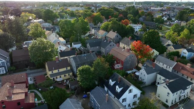New England USA. Colonial view. Houses in residential community in autumn fall foliage. Aerial establishing shot.