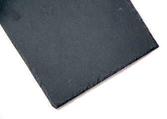 Dark Grey Black Slate Board for Dishes on White Background with Copy Space Natural Light Selective Focus