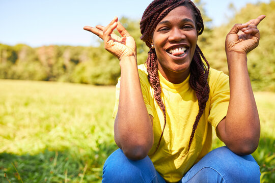 Confident Young Woman With Rasta Braids On Meadow