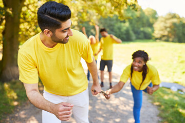 Young people at the relay race as an exercise for cooperation