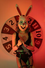 Girl dressed as a scary rabbit with a knife. halloween concept