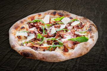 Pizza Carbonara with bacon, chanterelles, arugula, mozzarella, parmesan, pesto. Neapolitan round pizza on wood background