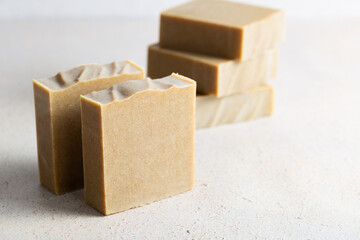 Natural handicraft brown soap bars on light background.