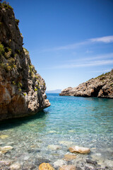 Exotic beach in Greece with clean waters and rocks Foneas beach