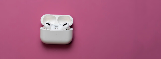 white opened case with wireless earphones