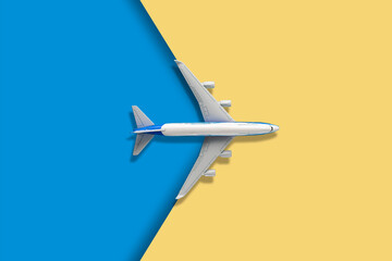 top view of a plane on a two color backgroind creative travel concept and copy space