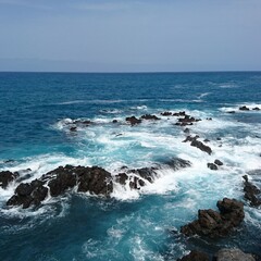 Waves over volcanic rocks on the promenade of Puerto de la Cruz on Tenerife 