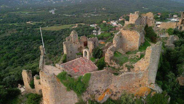 Ruined castle in Europe aerial footage cinematic medieval era Spectacular aerial views Palafolls Barcelona Maresme photographic tourism