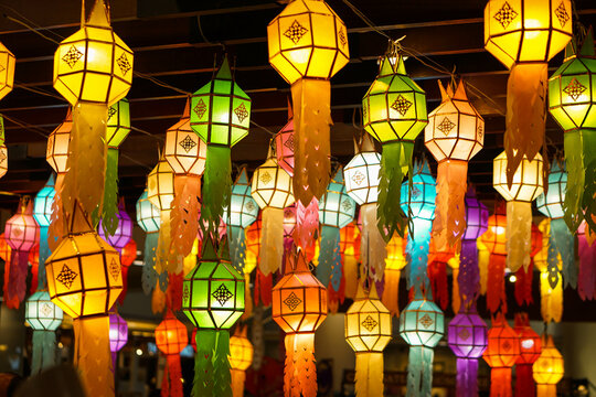 Closeup Colorful perspective view of Thai Lanna style lanterns to hanging on the ceiling and turn on light at night.
