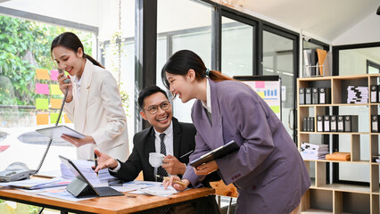 Professional Asian businesspeople enjoy working together, having a productive work day