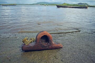 old rusty anchor near beach 