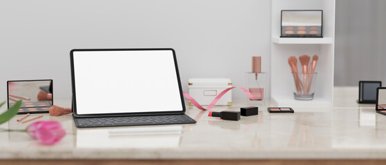 Beauty blogger or influencer working desk with tablet mockup, face makeup products and decor