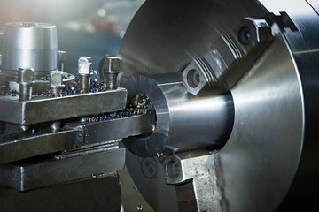 Closeup processing a metal pipe on a lathe.