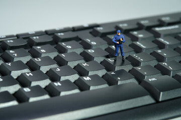 Miniature people toy figure photography. Data input privacy concept. A security officer standing...