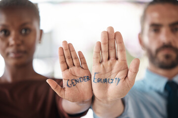 Hands, gender equality and unity with a sign message on the hand of a business man and woman in the office. Team, diversity and empowerment with a male and female employee standing in solidarity