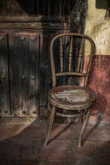 Rustic chair in a antique village in Spain, Vintage style, with old stone and wood background