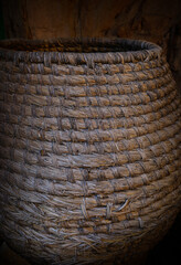 Old wicker basket, in a rustic town in Spain, Vintage style, with old stone and wood background
