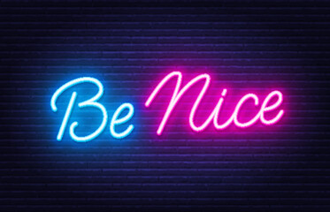 Be Nice neon quote on brick wall background.