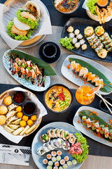 Sushi. Colorful tasty sushi and quality set of dishes on the party table