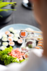 close up of a chef holding sushi