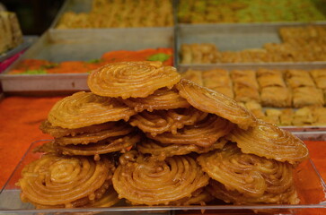 Turkish baklava. Eastern market, counter. Arabic dessert made from honey and syrup. Oriental sweets with peanuts, almonds and pistachio nuts. Close-up