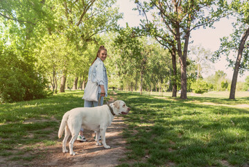 Young woman adopt young dog Labrador Retriever from animal rescue center and gave him love and...