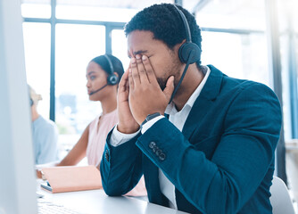 Fototapeta premium Stress, customer support and call center employee with a headache in a workplace with headset. Customer service, crm and bored African ecommerce sales man with burnout working in telemarketing office