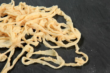 Pork casings in salt on black stone plate, ingredients for making sausages