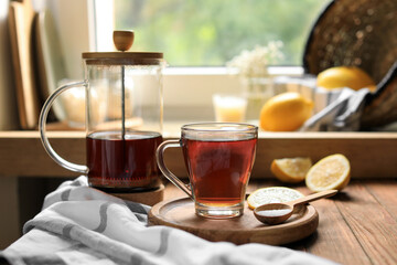Delicious tea, sugar and lemon on wooden table